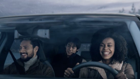 Three passengers riding in a vehicle and smiling | Jim Click Nissan in Tucson AZ