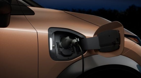 Close-up image of charging cable plugged in | Jim Click Nissan in Tucson AZ