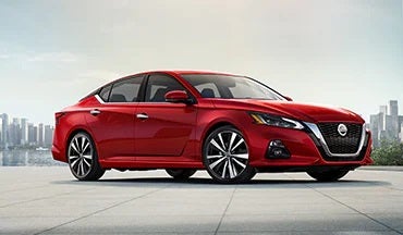 2023 Nissan Altima in red with city in background illustrating last year's 2022 model in Jim Click Nissan in Tucson AZ