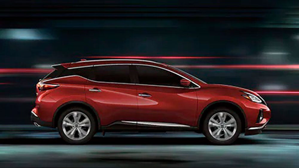 2023 Nissan Murano shown in profile driving down a street at night illustrating performance. | Jim Click Nissan in Tucson AZ